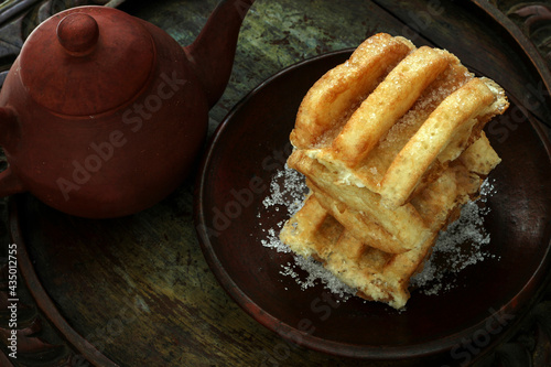 Gandos / Kue Rangi, is Indonesian traditional street food, made from rice powder and grated coconut served with sugar. photo