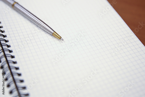 Close-up notebook or note book diary with a pen or pencil on top view desk or boardroom table for meeting notes.