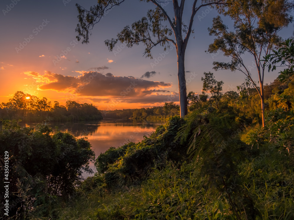 Fototapeta premium Late Afternoon Light on a River withCloud Reflections
