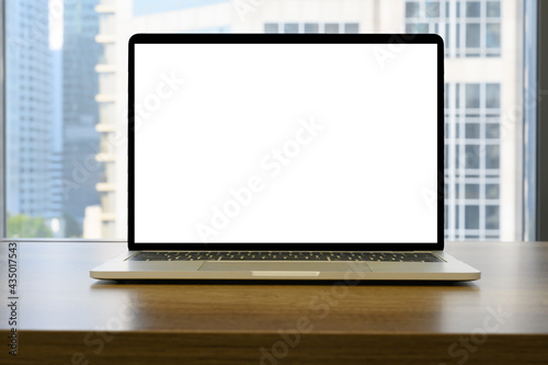 laptop with blank space on wooden table in the office and bokeh background