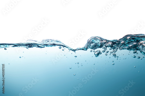Beautiful water waves splashing water waves in clear blue water, creating beautiful bubbles.