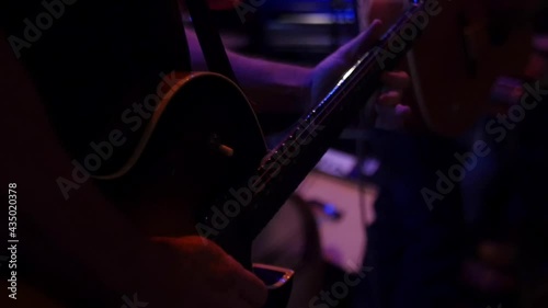 Close up of a musician playing electric guitar on stage.