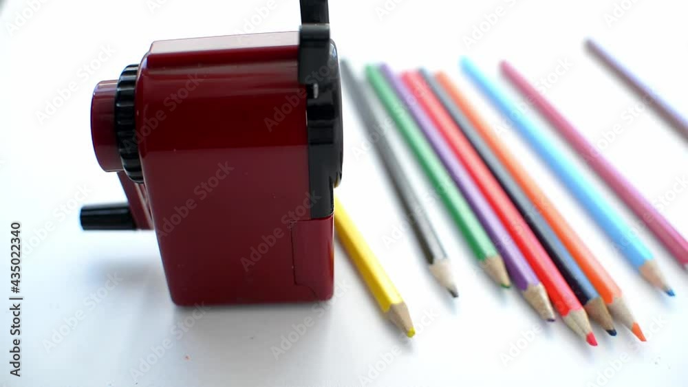 Mechanical pencil sharpener with colored pencils on a white background. back to school. preparing for school stationery for study