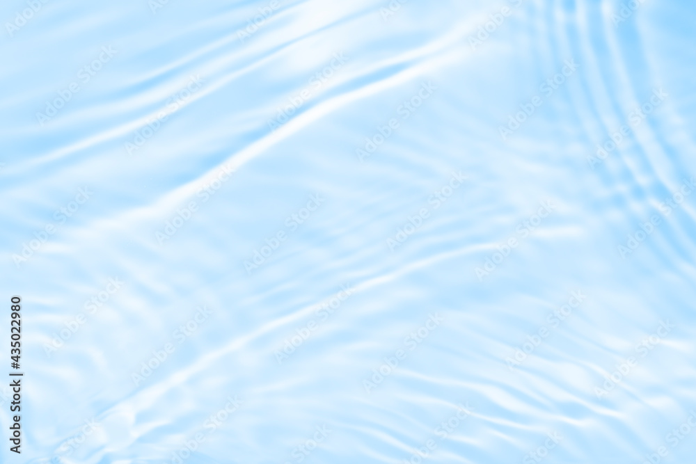 Surface of blue swimming pool. Texture of transparent blue water in swimming pool. Trendy abstract nature background. Water waves in sunlight with copy space Surface of blue swimming pool. Texture of transparent blue water in swimming pool. Trendy abstract nature background. Water waves in sunlight with copy space