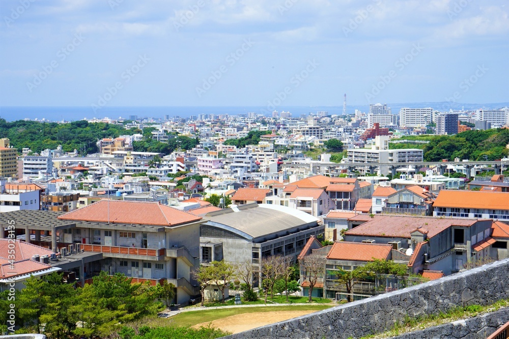 Aerial view of Naha city and sea shore from Shurijo castle in Okinawa, japan. Panorama - 沖縄 那覇市の街並みと海