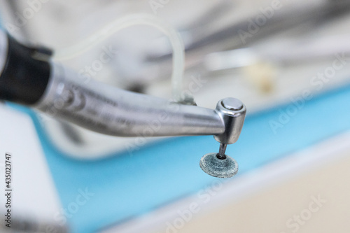 Close-up on dental surgery handpiece burr with round tip for polishing