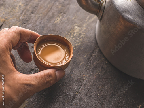 Photography Indian chai in glass cups with metal kettle and other masalas to make the tea