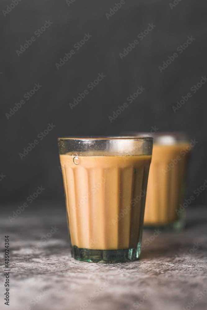 Indian chai in glass cups with masalas to make the tea. Stock