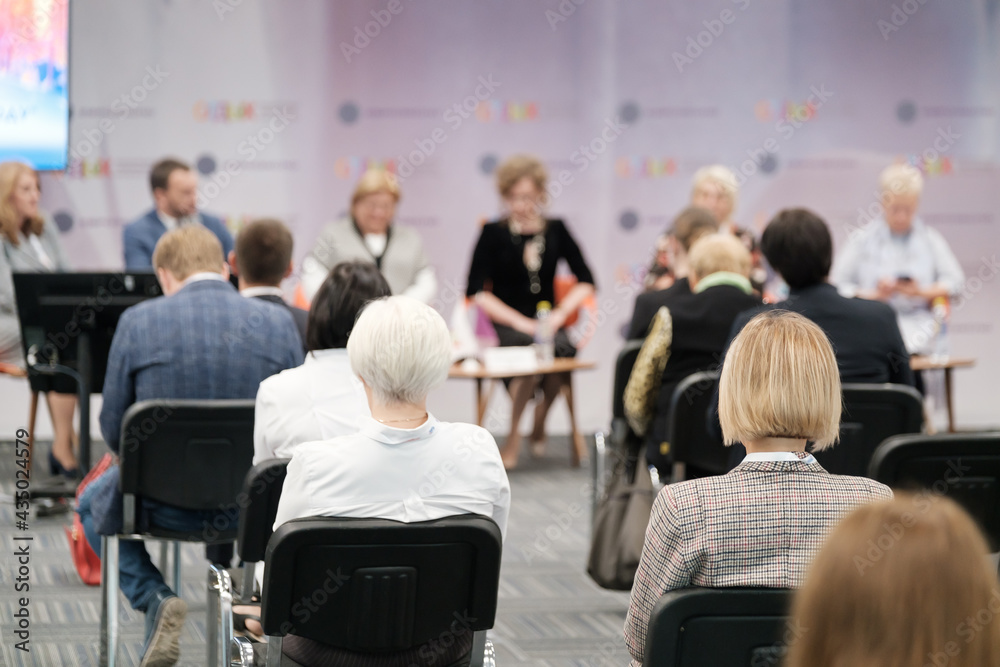 Business speaker doing presentation to audience Business speaker doing presentation to audience