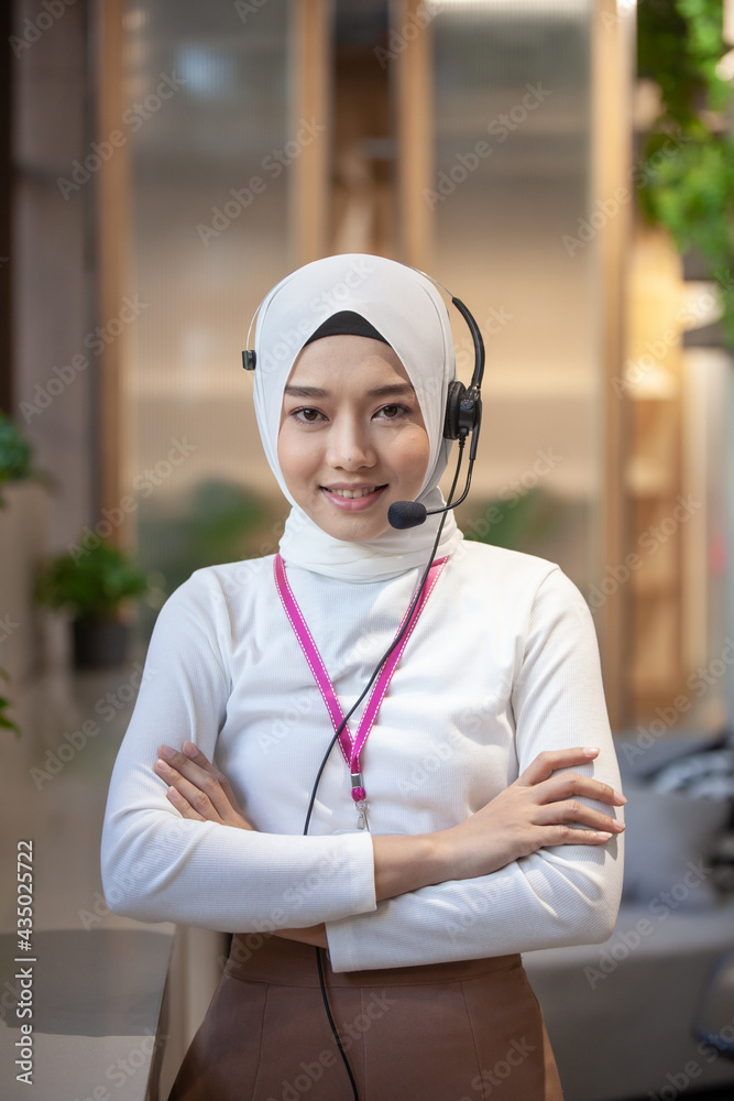 Portrait of happy smiling female customer support phone operator at workplace. Portrait of Asian beautiful smiling woman customer support phone operator in office .Concept call center job service.