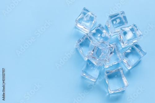 Acrylic ice cubes, Plastic ice cubes on light blue background. 