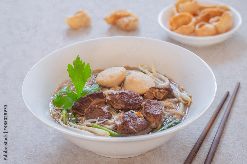 Noodle soup with braised pork and pork balls in bowl, Thai food style Noodle soup with braised pork and pork balls in bowl, Thai food style