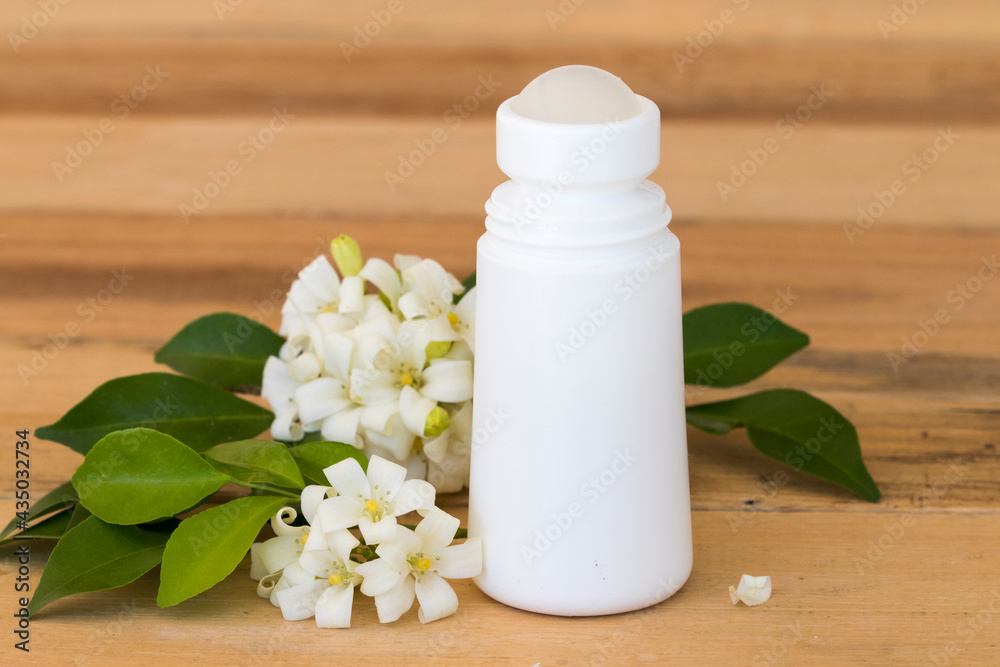 roll on deodorant antiperspirant fragrance flower health care for surface armpit with white flowers jasmine arrangement flat lay style on background wooden