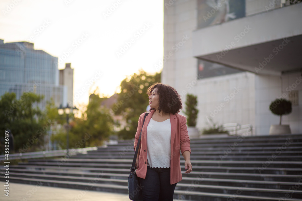 Business woman walking trough city alone. Business woman walking trough city alone.