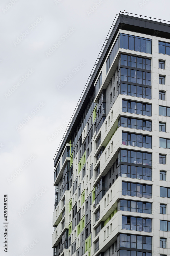 High modern residential building against a clear sky with a composition on the right edge. High modern residential building against a clear sky with a composition on the right edge.