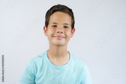 Young handsome boy standing on white studio background.