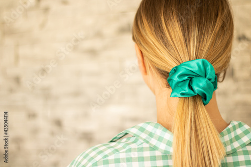 Closeup shot of a blonde female with a ponytail