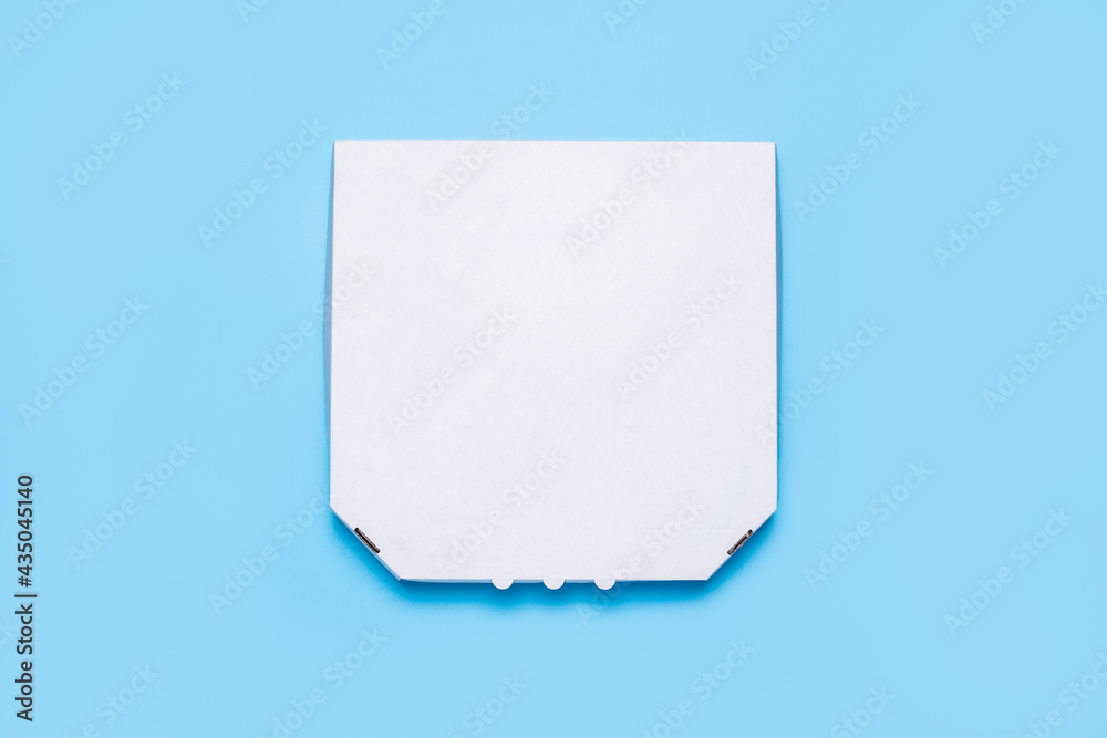 closed packaging of pizza on a blue background. Top view, flat lay closed packaging of pizza on a blue background. Top view, flat lay