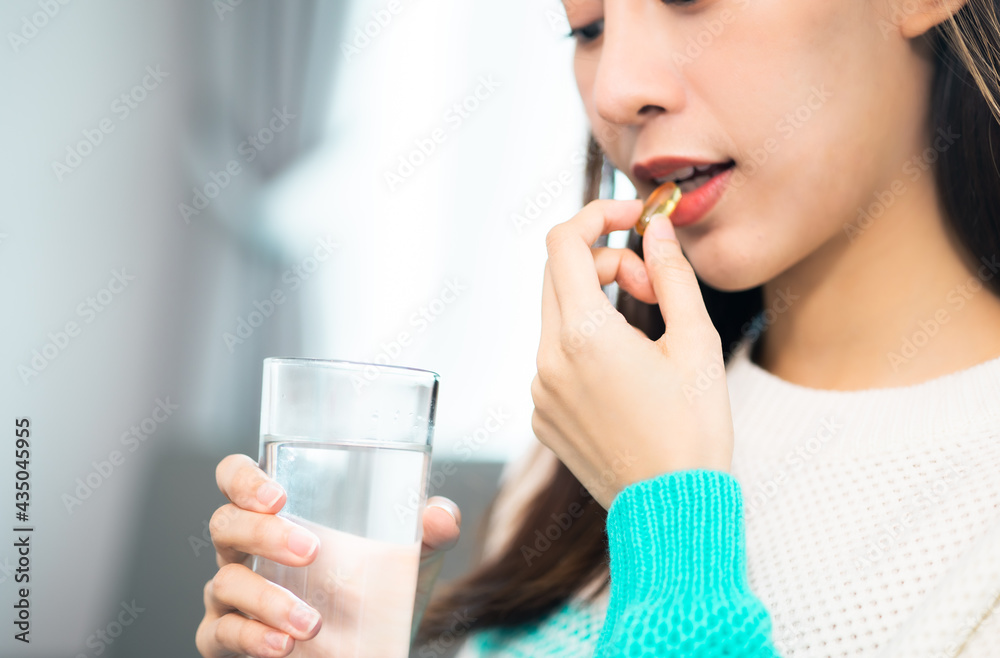 young beauty asian Pregnant woman holding vitamin pill isolated at home.healthcare and medical concept. young beauty asian Pregnant woman holding vitamin pill isolated at home.healthcare and medical concept.