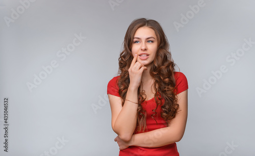 Dreamy young brunette woman, looking aside thoughtful, imaging or pondering about something