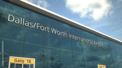 Airliner landing reflecting in the windows with Dallas Fort Worth International Airport text photo