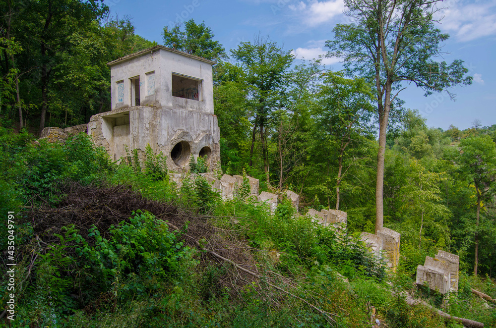 An old power station among green trees, Buky Canyon Ukraine, the Hirskyi Tikych river, the Cherkasy Oblast