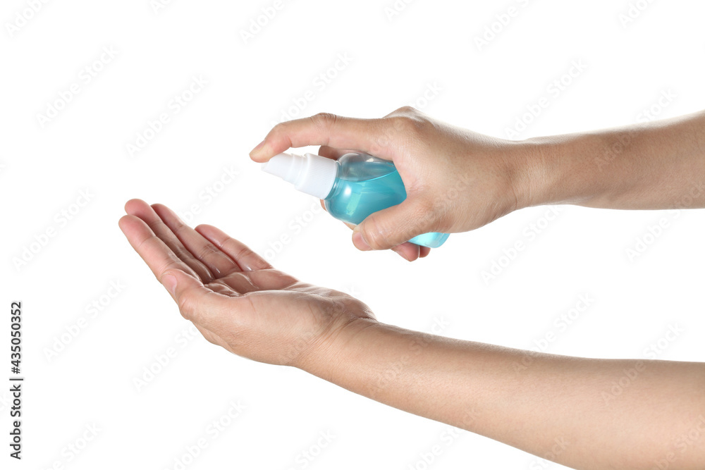 Fototapeta premium woman using antibacterial hand sanitizer spray on white background
