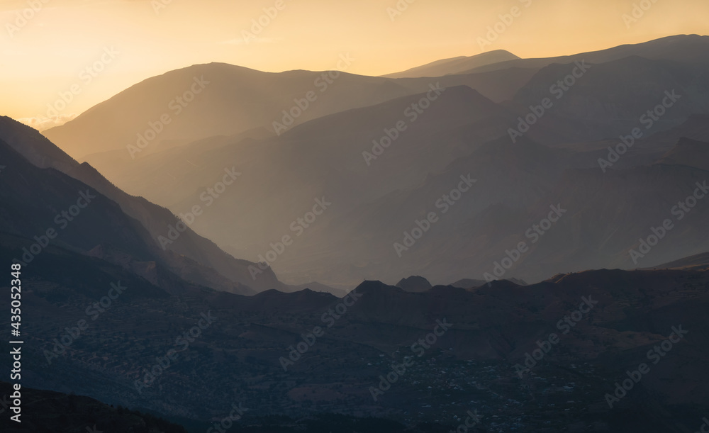 Golden sunset in mountain landscape. Silhouette of the evening mountains at sunset. Golden sunset in mountain landscape. Silhouette of the evening mountains at sunset.