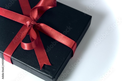 A gift box tied with red ribbon © ShivankB