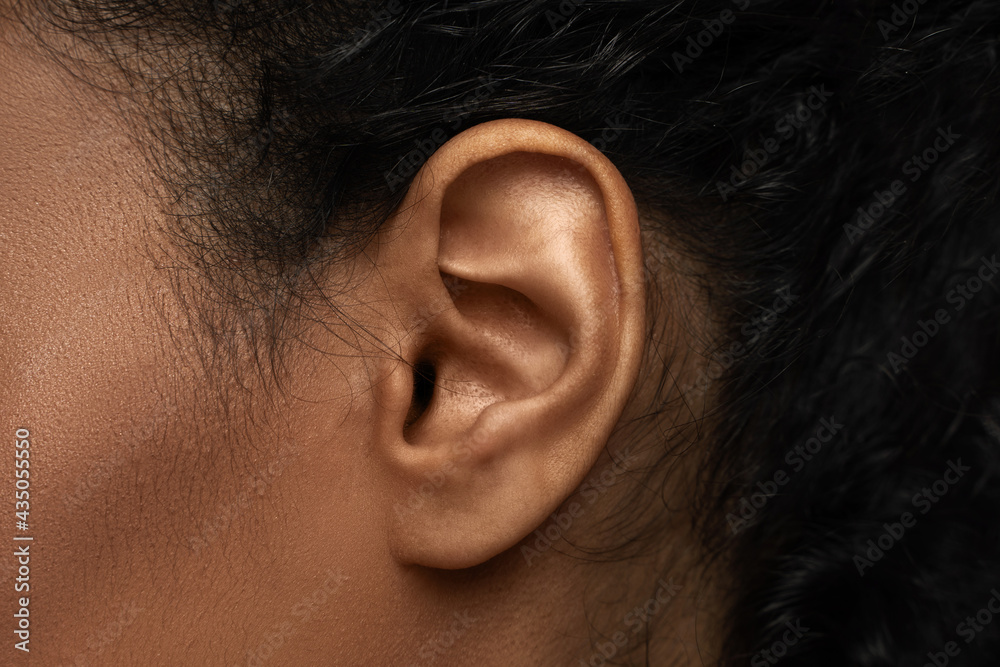Closeup view of black female ear - obrazy, fototapety, plakaty 
