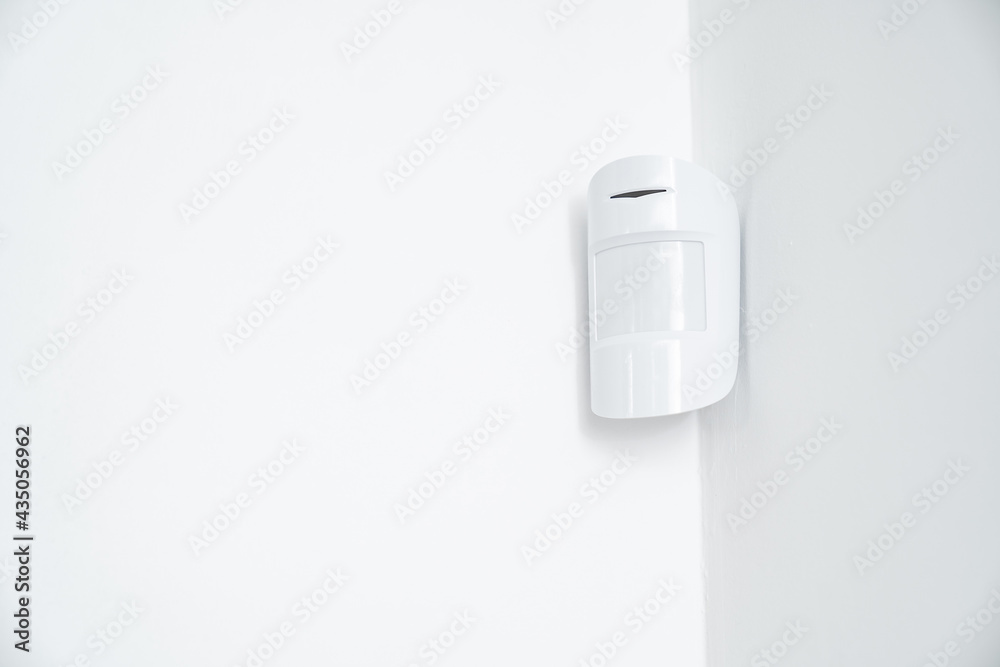 motion sensor in the white corner. device that tracks movement of objects. motion sensor in the white corner. device that tracks movement of objects.
