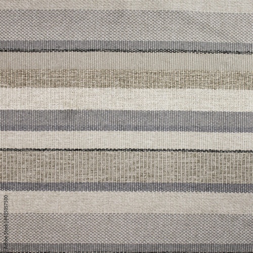 Horizontal striped upholstery fabric texture, linear patterns in shades of grey, beige, and tan