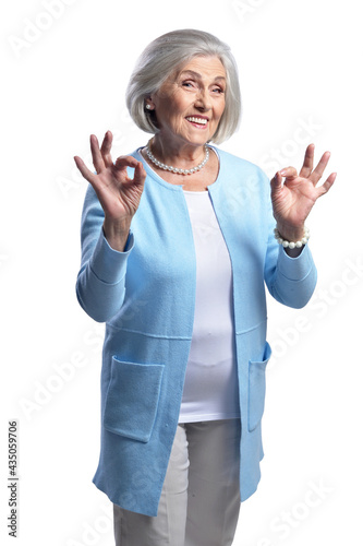 portrait of beautiful senior woman showing ok signs