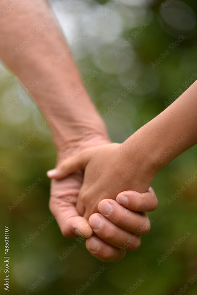 person holding granddaughter's hand person holding granddaughter's hand