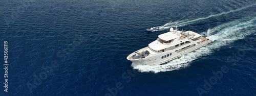 Aerial drone ultra wide photo of luxury yacht cruising in deep blue sea near Mediterranean Aegean island © aerial-drone