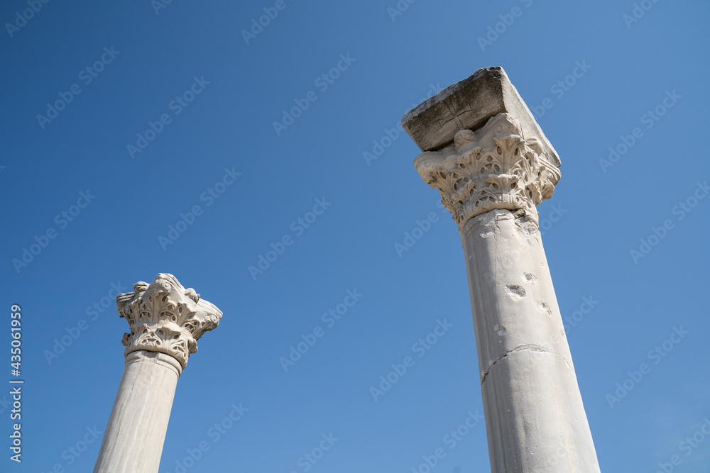 Corinthian style marble columns against blue sky at Perge, once the capital of Pamphylia Secunda, the ancient city near Antalya, Turkey