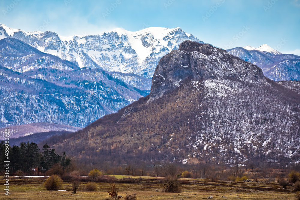 Zir hill and Velebit mountain snowy peaks in Lika landscape view
