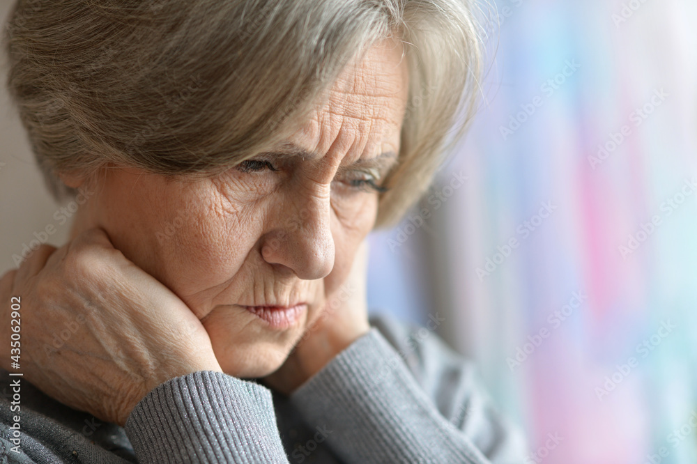 Close up portrait of sad senior woman at home Close up portrait of sad senior woman at home