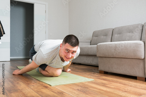 Man doing exercise at home. Indoor home workout concept. Keep healthy lifestyle concept