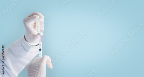 Close up doctor, nurse, scientist hand gloves holding flu, measles, coronavirus,vaccine disease preparing, adult, man and woman vaccination shot, medicine and drug concept copy space blue background.