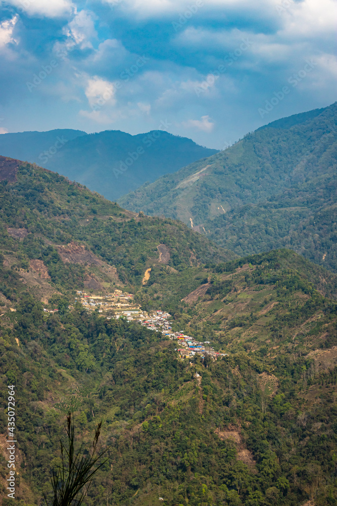 mountain range with dense green forests at morning from flat angle