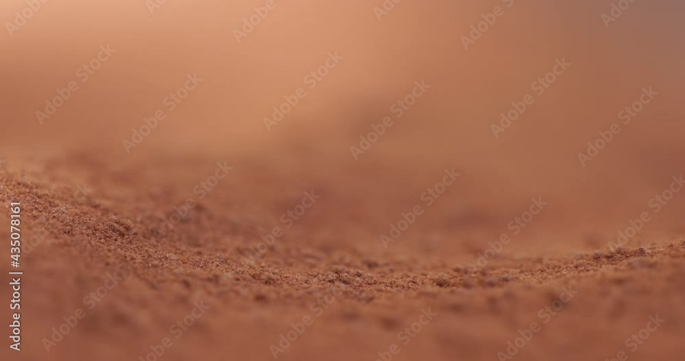 Powder flowing as sand like object closeup