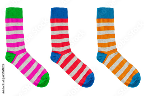 Three socks with different lines isolated on white background. Colorful socks son white background. Colored socks on the leg isolated on white background
