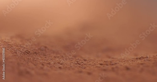 Powder flowing as sand like object closeup