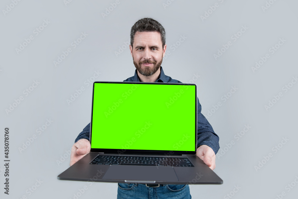 office manager ready for video conference. smiling man showing green laptop screen. office manager ready for video conference. smiling man showing green laptop screen.