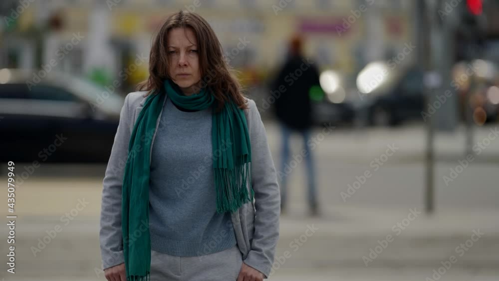 unhappy townswoman is walking in city, moving on street, medium portrait, sad face unhappy townswoman is walking in city, moving on street, medium portrait, sad face