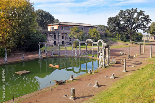 ancient pool called Canopus, surrounded by greek sculptures in Villa Adrian (Hadrian's Villa) and reflections in water in Tivoli, Italy photo