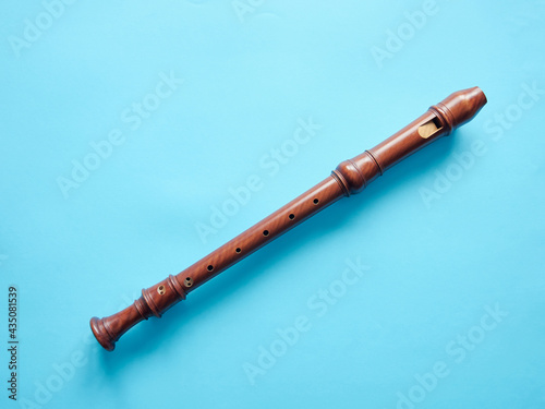 Baroque recorder isolated on blue background  with copy space