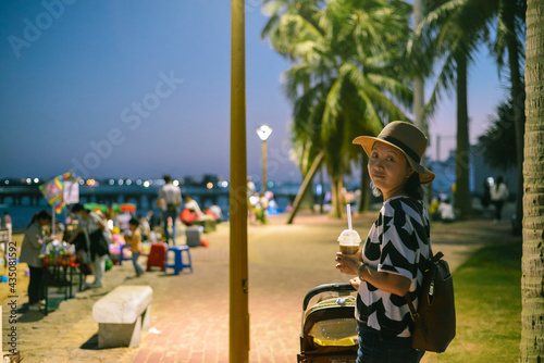 Young woman sits on beach when evening at Zhanjiang, Guangdong, China photo