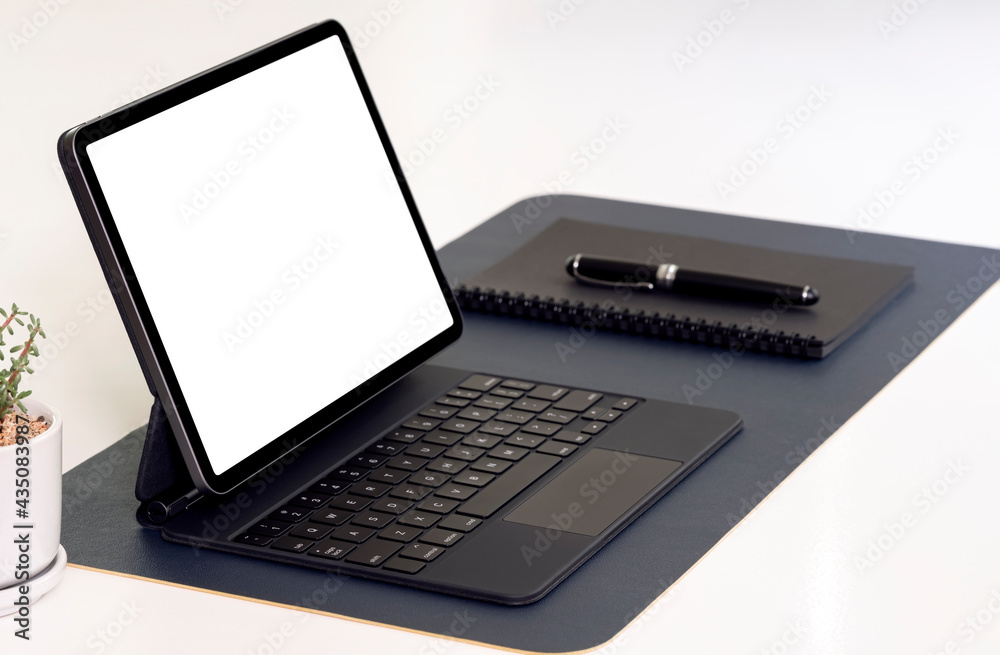 Mockup blank screen tablet with keyboard, notebook and pen on white table. Mockup blank screen tablet with keyboard, notebook and pen on white table.